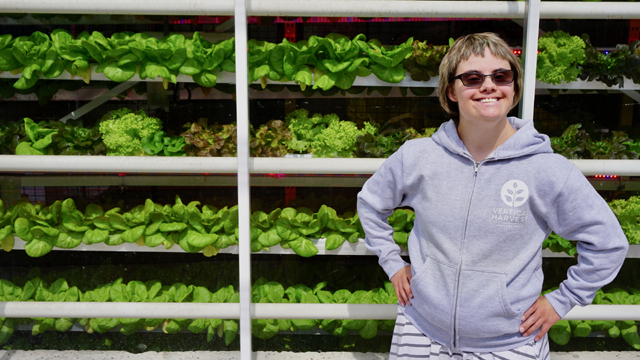Mycah Miller strikes a pose in front of the greenhouse